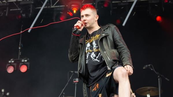 The Head Of Wargasm's Vocalist Was Pinned Down By Bouncers Below The Stage Latrine .